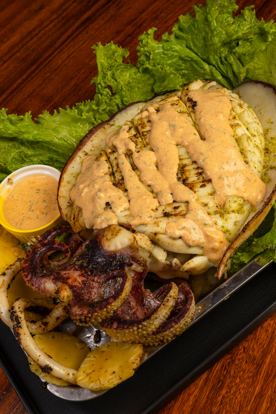 Grilled calamari and octopus platter with dipping sauce