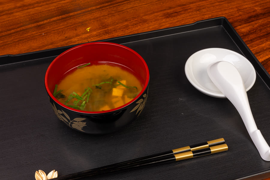 Creamy soup in a black bowl on dark slate