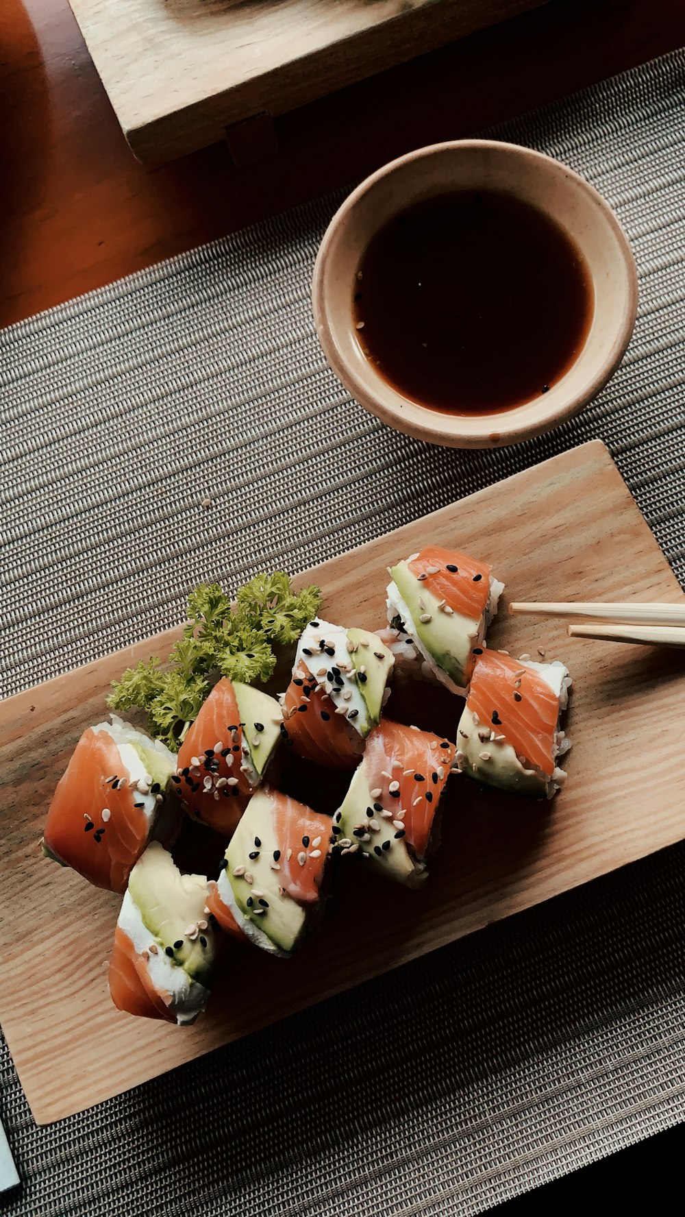 Sushi on a cedar board with soy and chopsticks